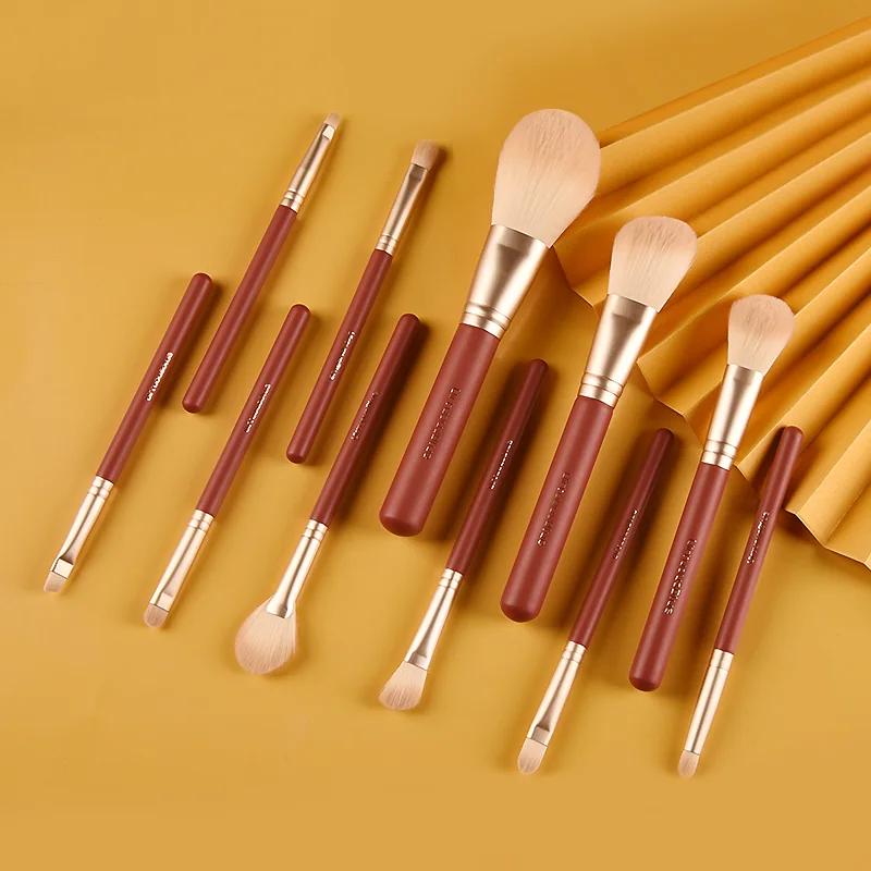Brown and gold face and eye makeup brush assortment