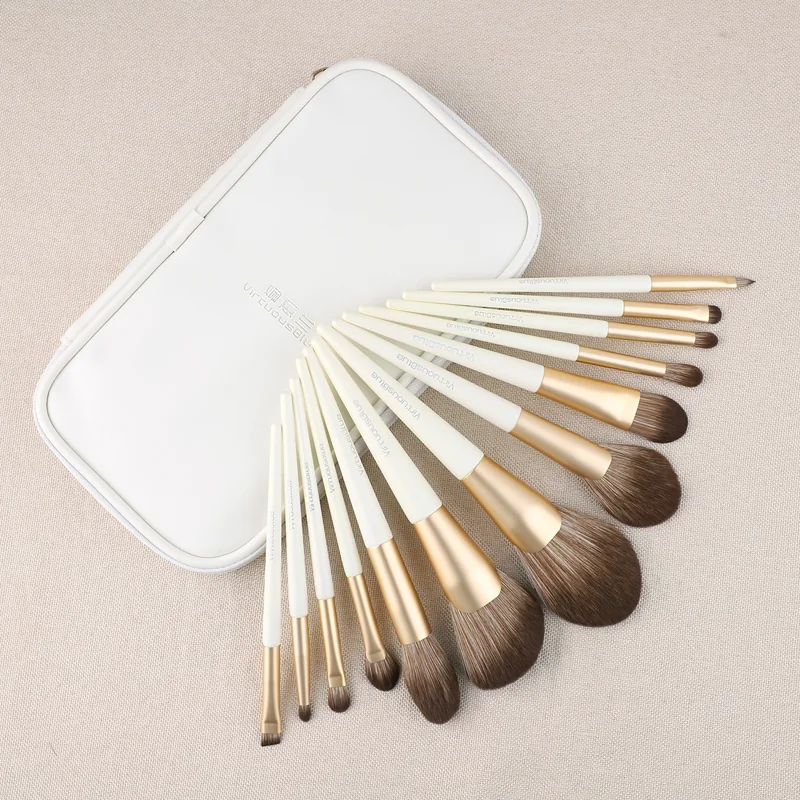 White handle travel brush set arranged in a metal presentation case