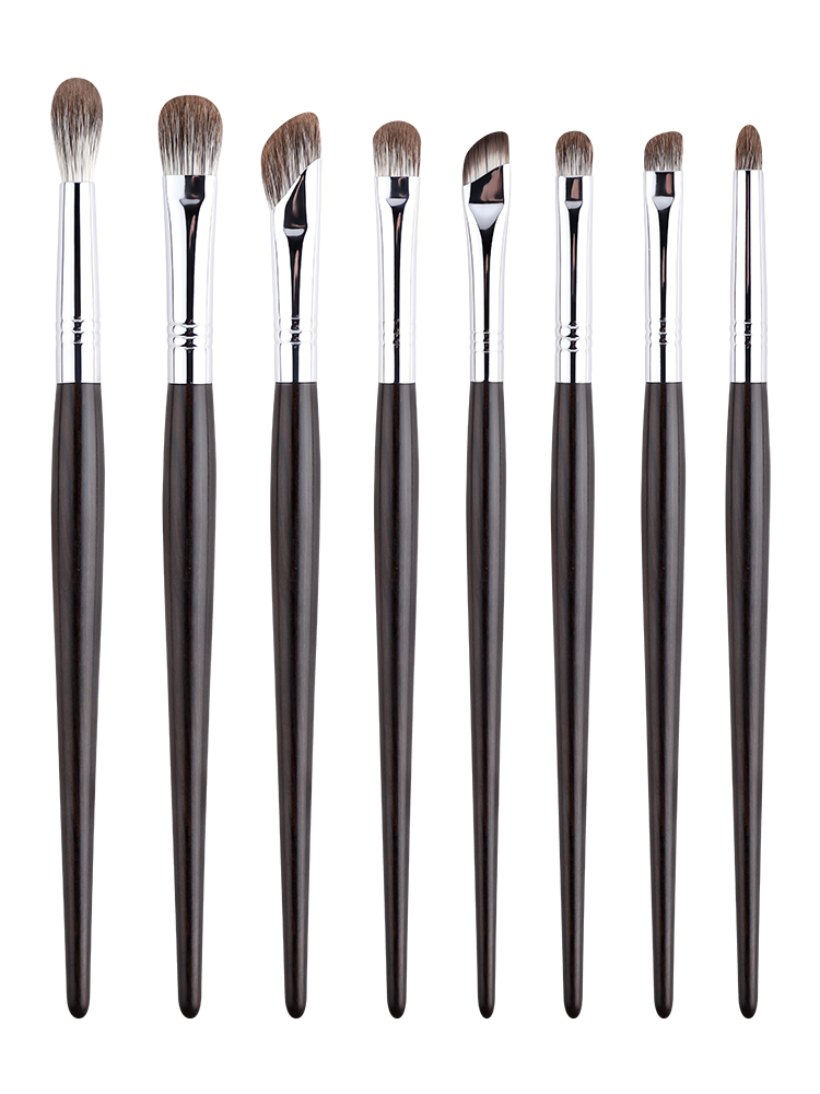 Eight-piece eye makeup brush set with dark wood-style handles on a white background